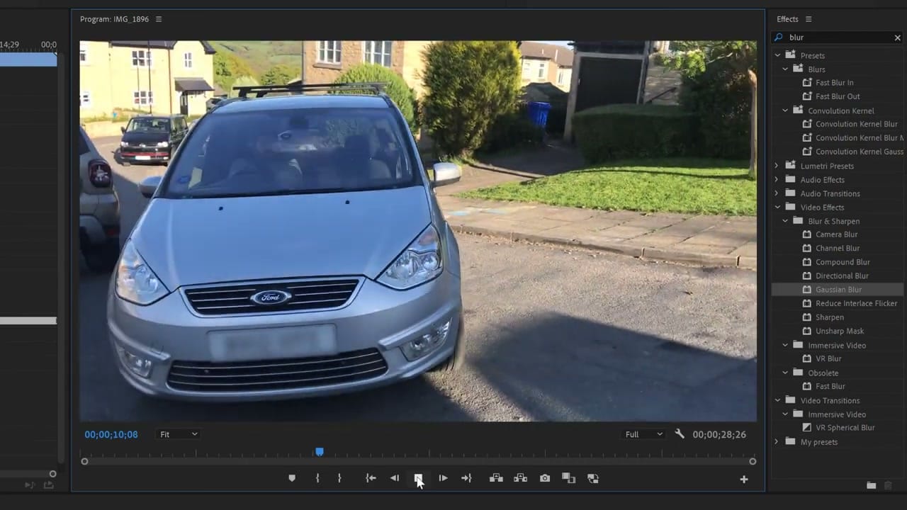 Final result showing a car with its license plate completely blurred using a tracked Gaussian Blur mask in Premiere Pro